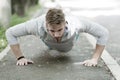 Strength and motivation. Man in sportswear doing push ups outdoor. Guy motivated workout in park. Sportsman improves his Royalty Free Stock Photo