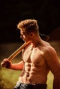 Strength and power concept. Forester with axe. Sexy macho bare torso. Surviving in wild nature. Muscular athlete in