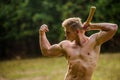 Strength and power concept. Handsome shirtless man muscular body. Forester with axe. Sexy macho bare torso. Surviving in