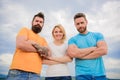 Strength in unity. Woman and men look confident sky background. Threesome stand confidently with folded arms. Threesome Royalty Free Stock Photo