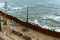 Construction of the promenade at sea, strengthening the sea coastline, special equipment on the beach Royalty Free Stock Photo