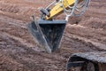 Strengthening the slope of the road with peat. Peat and excavator bucket. spring Latvia.