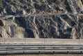 Strengthening the slope with a steel net anchored deep into the rock. falling rocks do not fall on the road. Double barriers are o Royalty Free Stock Photo