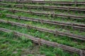 Strengthening a steep slope with wooden planks and posts that also serve as stairs or seating for watching football on the field Royalty Free Stock Photo