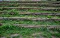 Strengthening a steep slope with wooden planks and posts that also serve as stairs or seating for watching football on the field Royalty Free Stock Photo