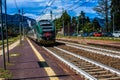 STRESA, ITALY - JULY 14, 2016. Stresa railway station and arriving train Trenord Italia.