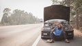 Stress african man calling for assistance or insurance with his car broken down by the roadside Royalty Free Stock Photo