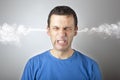 Stress and anger, angry upset man with head pressure and smoke coming out from his head Royalty Free Stock Photo