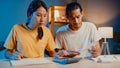 Stress asia couple man and woman use calculator for calculate family budget, debts, expenses during financial economic crisis at