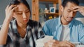 Stress asia couple man and woman use calculator for calculate family budget, debts, monthly expenses during financial economic