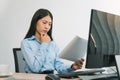 Stress asian woman while coding data programmer on desktop PC while working on computer codes in the office Royalty Free Stock Photo