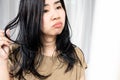 Asian woman have problems with oily hair and thinning hair looking at the mirro Royalty Free Stock Photo