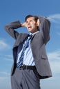 Stress, blue sky and a business man screaming outdoor in frustration from tax, debt or financial crisis. Burnout Royalty Free Stock Photo