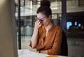 Stress, burnout and woman with a headache tired from working overtime at her office desk due to paperwork deadlines