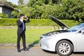 Stress businessman calling for help with car broken concept