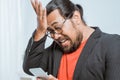 Stress businessman holding his phone at the office