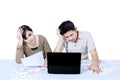 Stress couple paying bills online - isolated Royalty Free Stock Photo