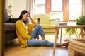 Stress, depression or burnout woman with laptop on living room floor for home finance, studying or house rent debt. Sad