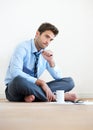 Stress, documents and thinking with a business man reading tax paper or a budget on the floor of his apartment Royalty Free Stock Photo