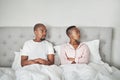 Stress, fight and black couple lying in bed angry, affair and divorce argument or insomnia. Mental health, relationship Royalty Free Stock Photo