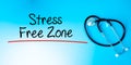 Stress Free Zone Sign.Text underline with red line. Isolated on blue background with stethoscope. Health concept Royalty Free Stock Photo