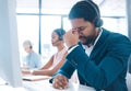 Stress, headache and call center with a man consultant suffering from pain or tension while working in customer service Royalty Free Stock Photo