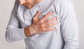 Stress and health concept. Young man experiences chest pain and leans