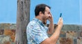 Stress and mad person, yelling and shouting to the phone in a call with blue background. Crazy Angry man calling with aggressive Royalty Free Stock Photo