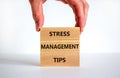 Stress management tips symbol. Wooden blocks with words `Stress management tips`. Beautiful white background. Doctor hand.