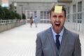 Stress out businessman with a note on his forehead Royalty Free Stock Photo