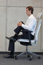 Stress reduction in office work - man exercising on chair Royalty Free Stock Photo