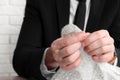 Stress relief. Businessman popping bubble wrap, closeup view. Space for text Royalty Free Stock Photo