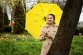 Stress resilience and mental health, concept. Managing stress and building resilience. Happy senior woman in yellow rain