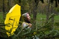 Stress resilience and mental health, concept. Managing stress and building resilience. Happy senior woman in yellow rain