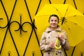 Stress resilience and mental health, concept. Managing stress and building resilience. Happy senior woman in yellow rain