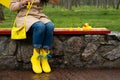 Stress resilience and mental health, no depression concept. Womens legs in yellow rubber boots and a yellow rubber duck