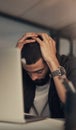 Stress is a sign that something needs to change. a young businessman feeling stressed while working late at night in a Royalty Free Stock Photo