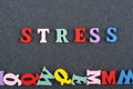 STRESS word on black board background composed from colorful abc alphabet block wooden letters, copy space for ad text. Learning Royalty Free Stock Photo