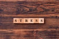 Stress word written on wood block on dark rustic wooden background. Feel worried and nervous stress concept Royalty Free Stock Photo