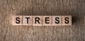 STRESS word written on wooden blocks on a brown background Royalty Free Stock Photo