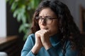 Young worried female employee in glasses feeling anxious, irritable or depressed at workplace Royalty Free Stock Photo