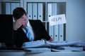 Stressed Accountant Holding Help Sign At Desk Royalty Free Stock Photo