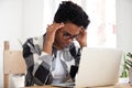 Stressed african woman concentrating doing difficult online computer work