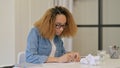 Stressed African Woman Unable to Write on Paper