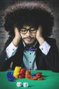 Stressed Afro man with chips on table