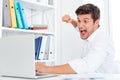Stressed angry businessman hitting laptop with fist