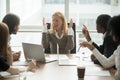 Stressed angry businesswoman arguing at meeting with male collea