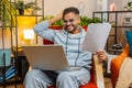 Stressed angry Indian man looking at unpaid bank debt loan bills, doing paperwork planning budget Royalty Free Stock Photo