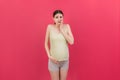 Stressed or angry pregnant woman. Pregnancy mother problems on colored background isolated