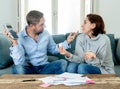 Stressed young couple having an argument over credit car debts payments and home finance